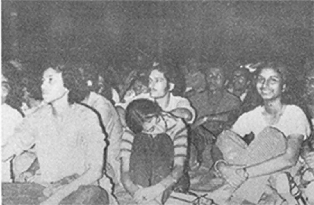 The front rows of the audience, grinning