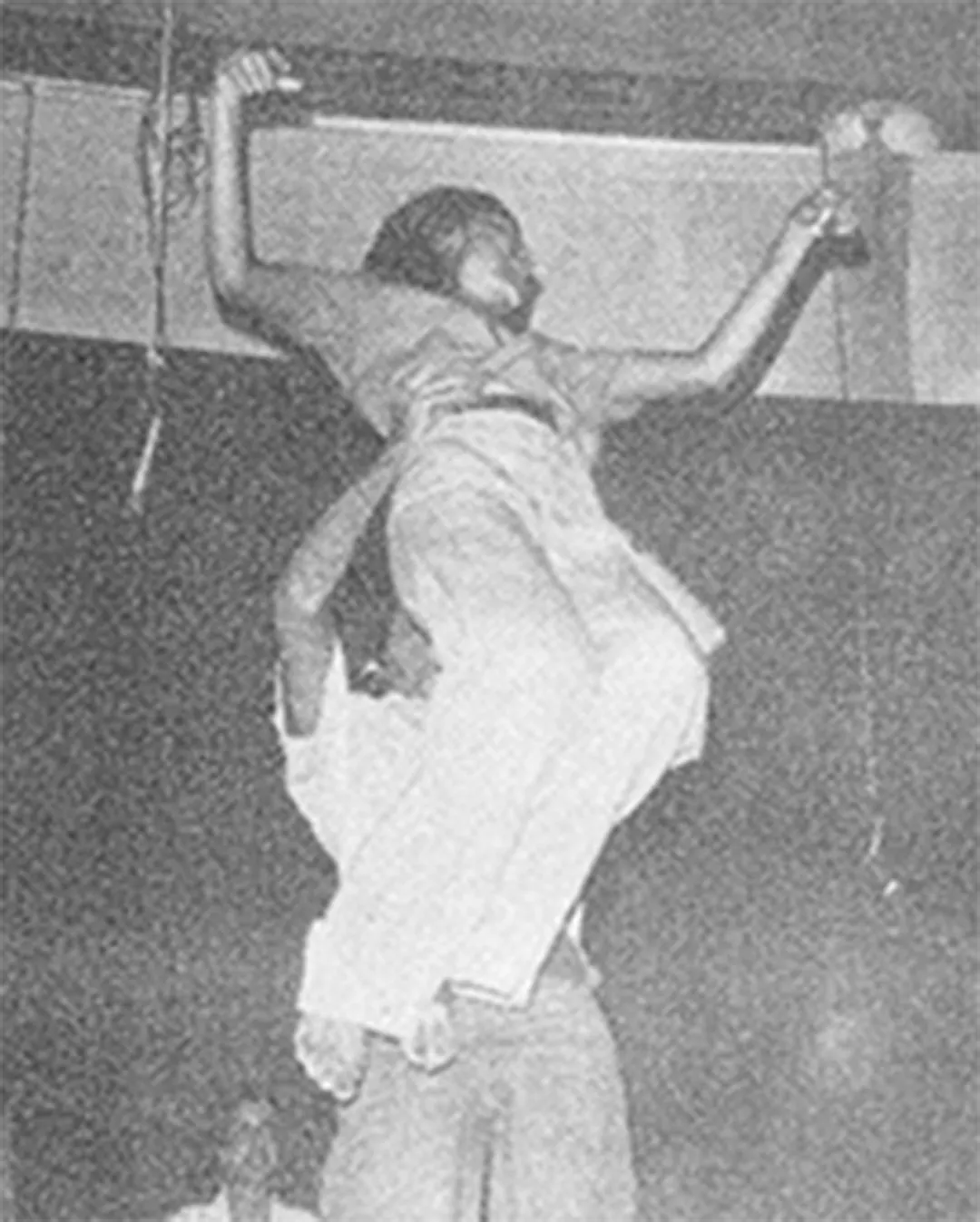 A performer climbs onto another’s shoulders