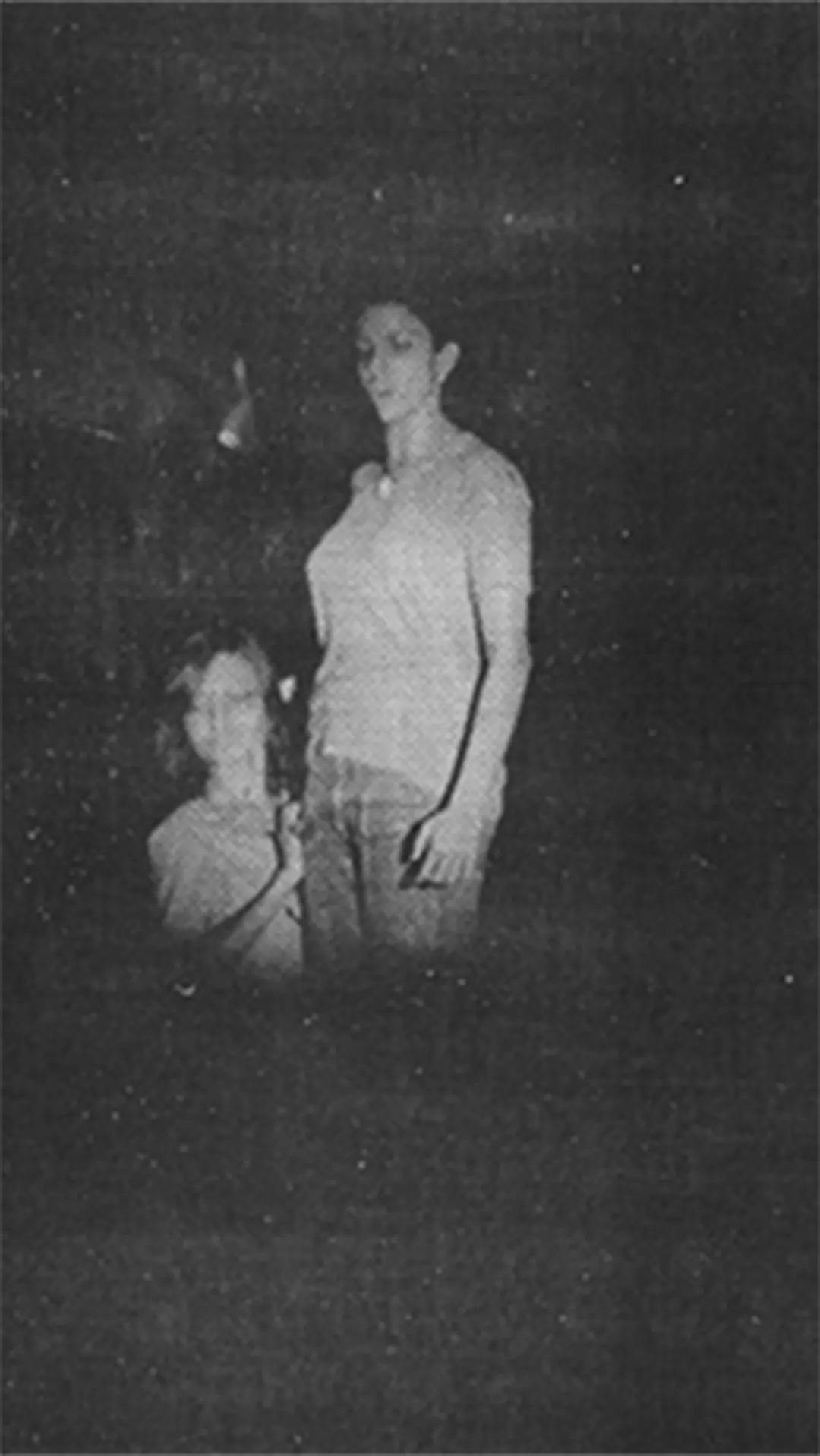 A woman alone on a dark stage