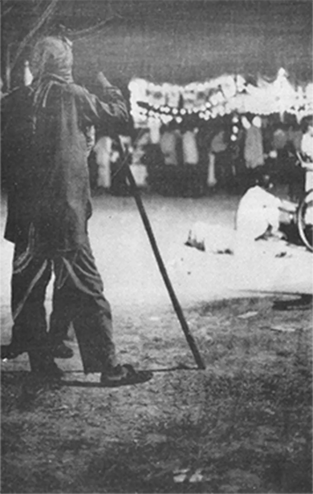 An outdoor performance at night, a crowd looking on