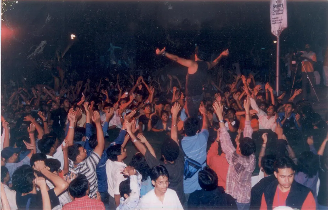 Hands up in a packed crowd at a night show