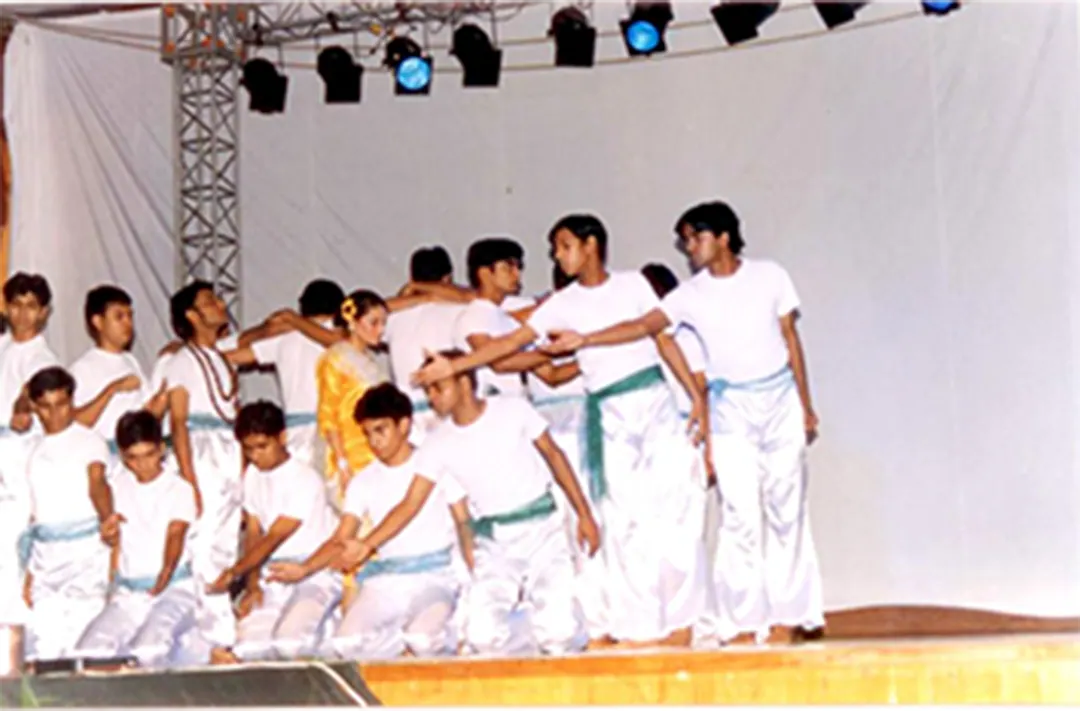 A dance group in white mid-routine