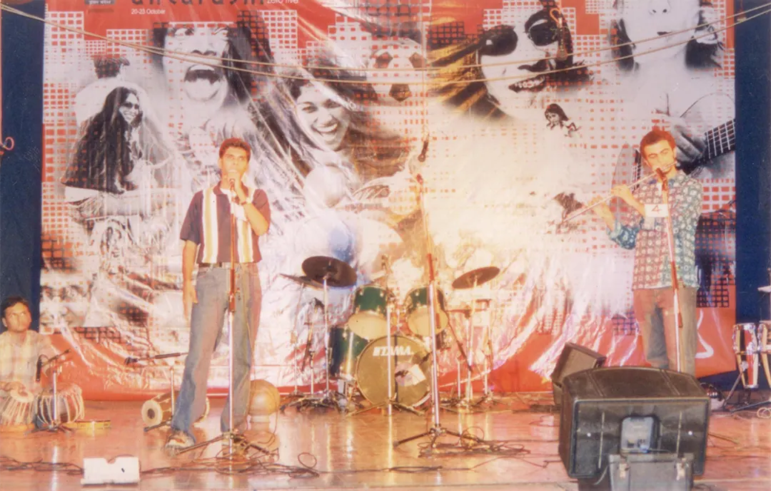 Two singers in front of a huge collage backdrop