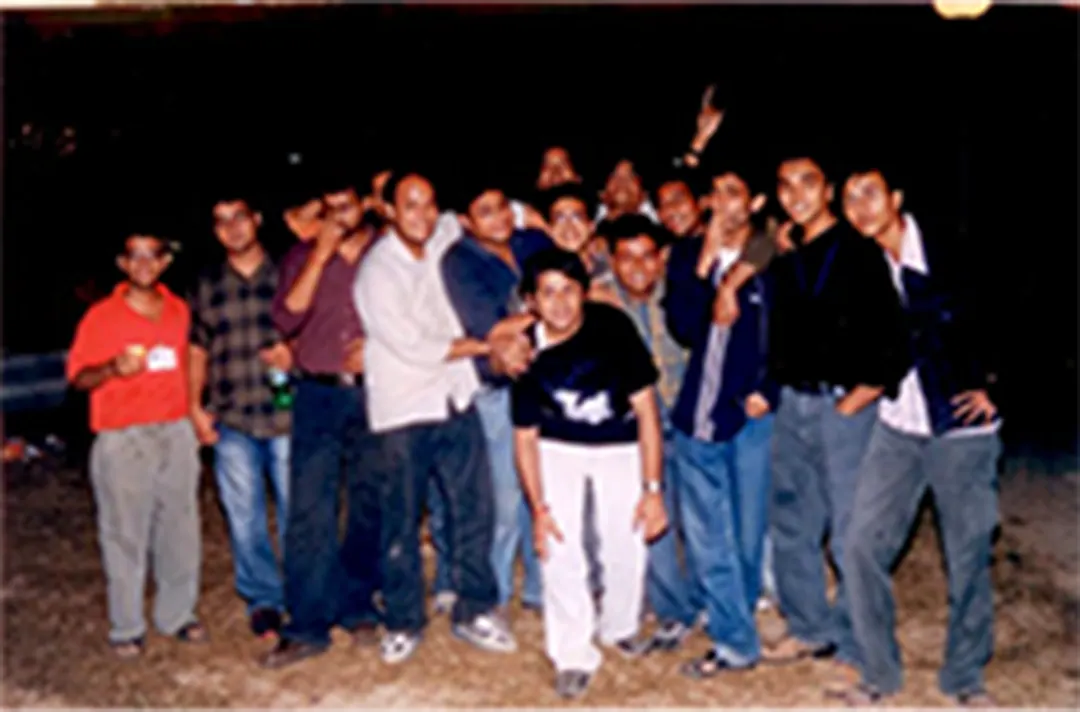 A big group of friends posing at night