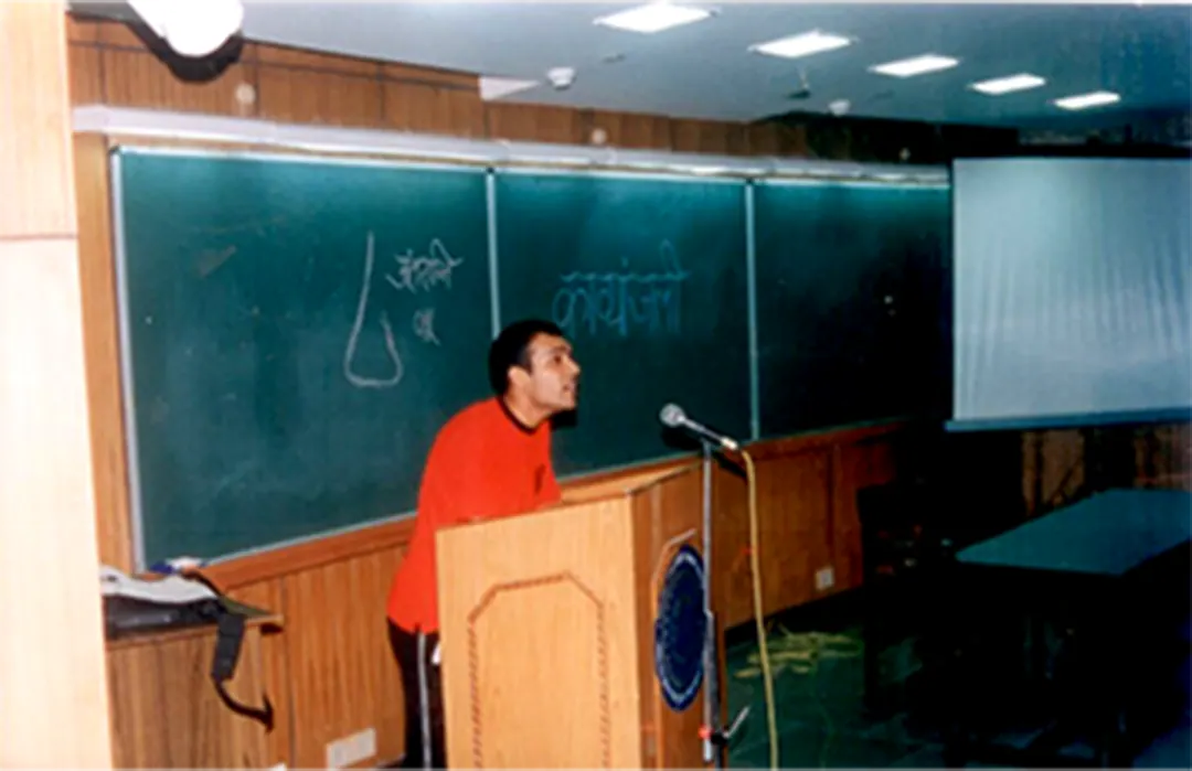 A speaker at the podium in a lecture hall
