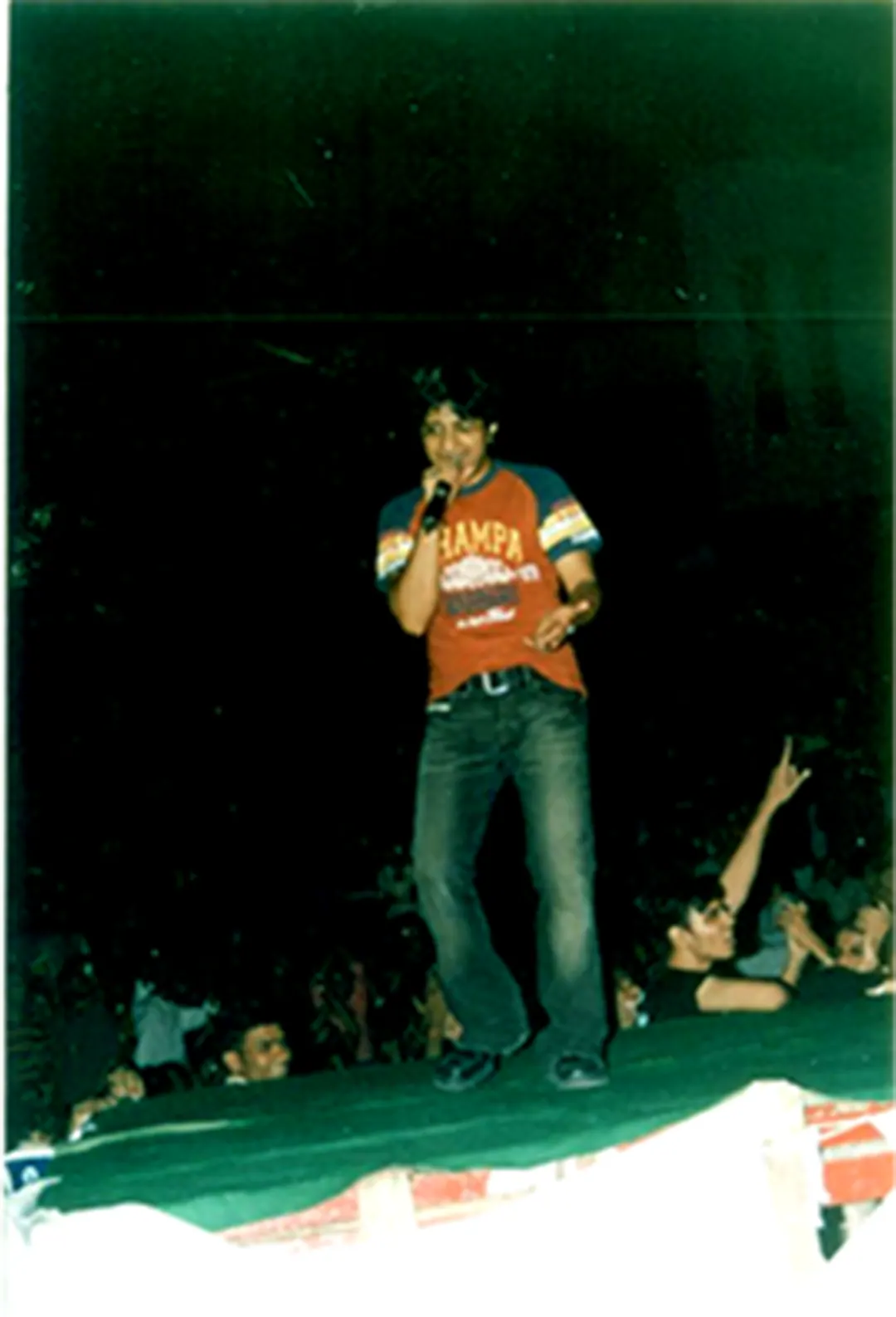 A singer works the crowd from the stage edge